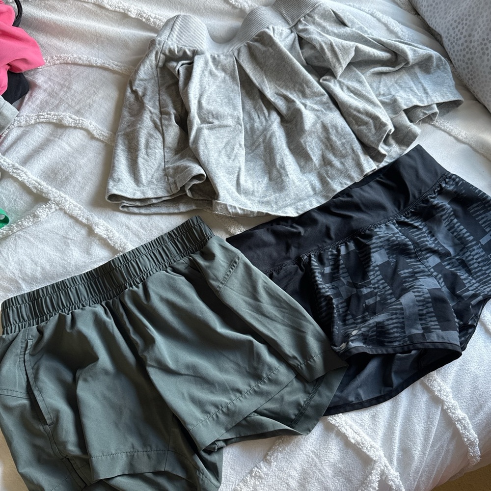 Set of Three Athletic Shorts in Black, Green and a grey skirt. All size xs.